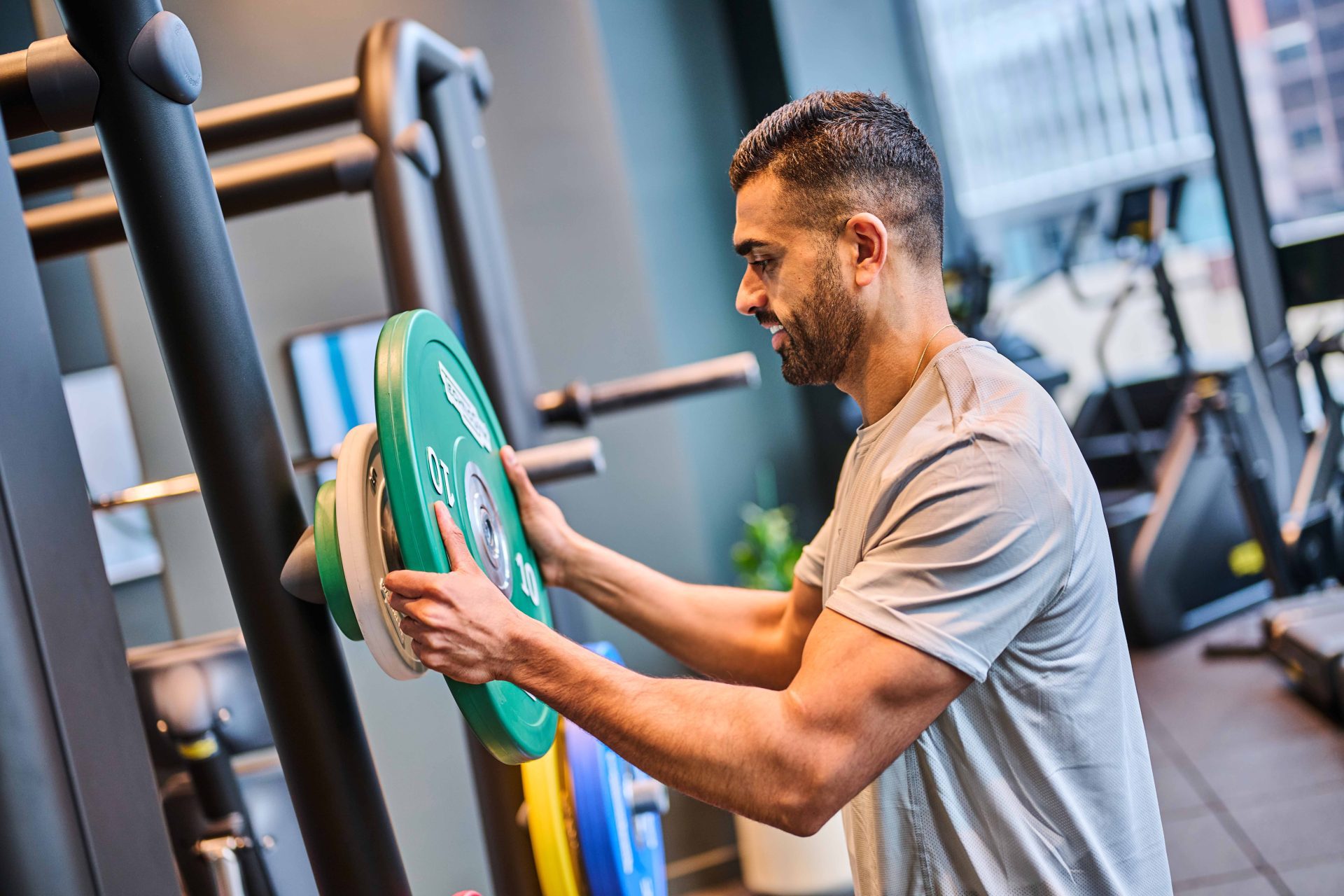 Resident using gym equipment in The Octagon luxury apartments fitness suite