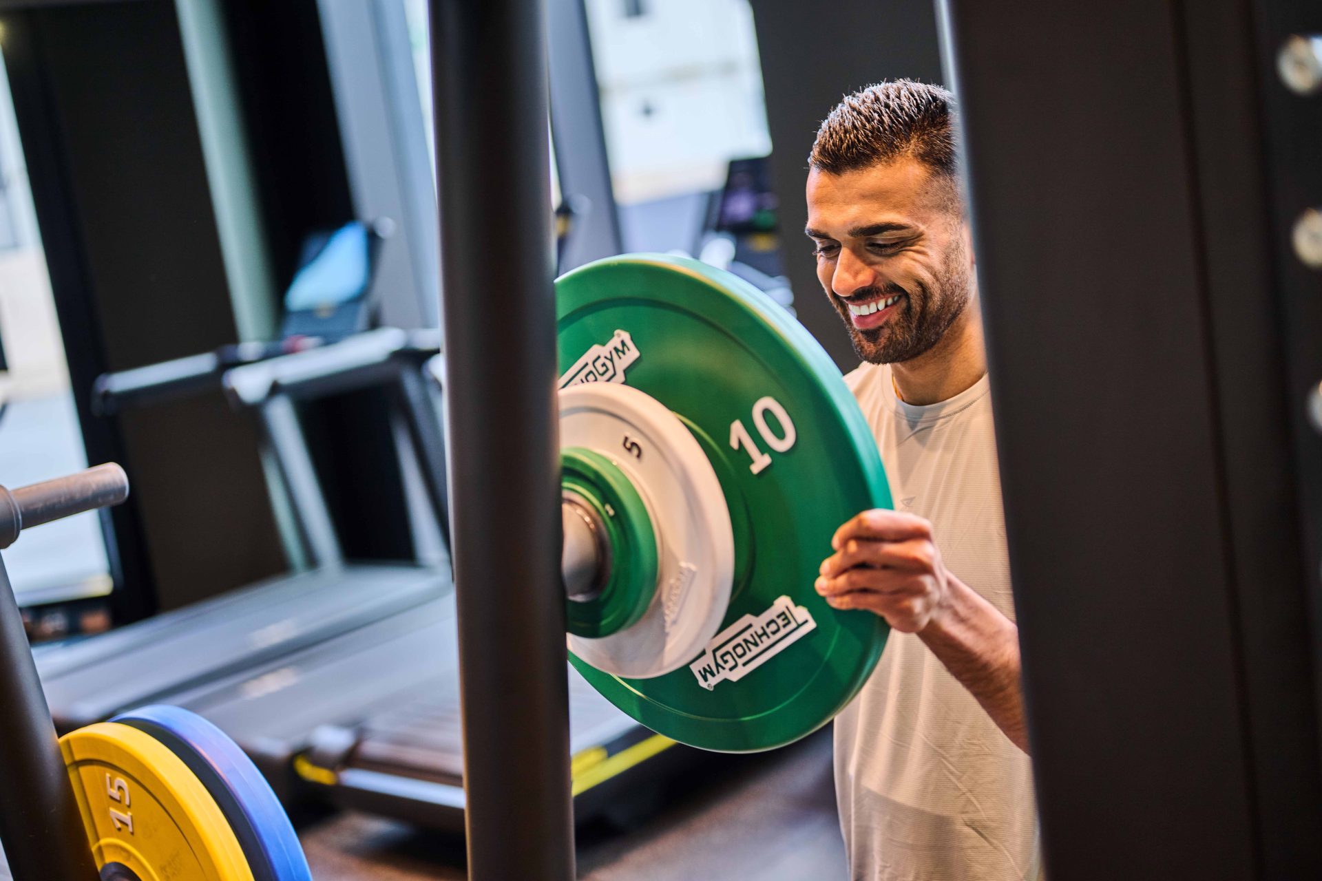 Male tenant using weights in The Octagon gym, luxury apartments available to rent