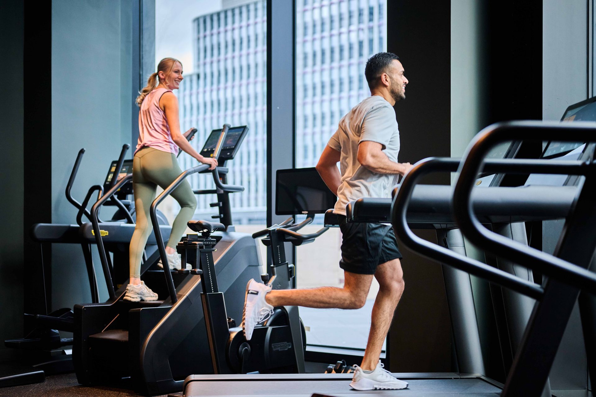 Residents using gym equipment and exercising in The Octagon communal fitness space
